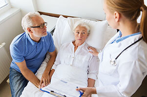 Physician with patients at bedside