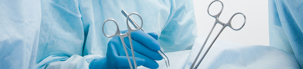 Photo of surgeon using surgical tools