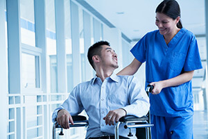 Nurse pushing patient in wheel chair