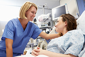 Nurse bedside with patient